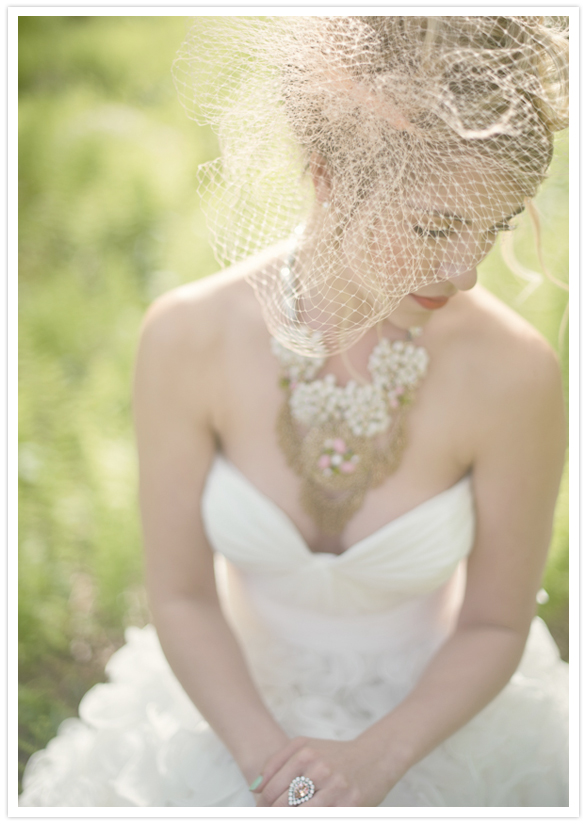 ornate gold necklace, blusher veil and ruffled wedding dress