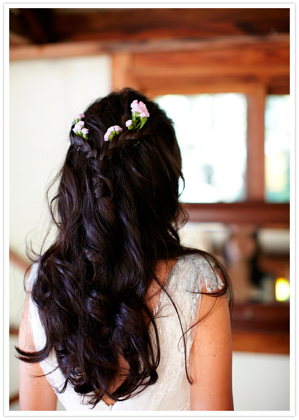 simple curls and braided crown with floral accents simple curls and braided crown with floral accents