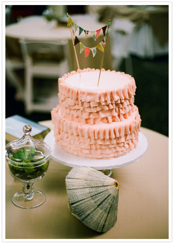 ruffled pink cake and bunting topper