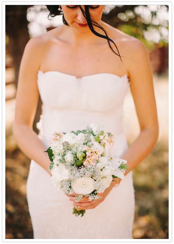 white ranunculus, peach stock, white lilies, bishop's lace, sage, snapdragons, pale pink garden roses, and seeded eucalyptus bouquet