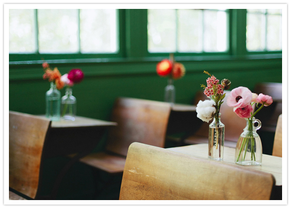 wooden desks and whiskey bottle vases