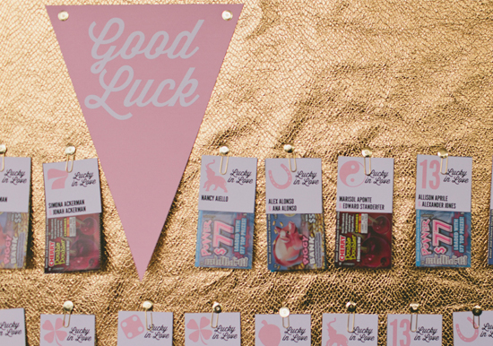 gold and pennant escort card board