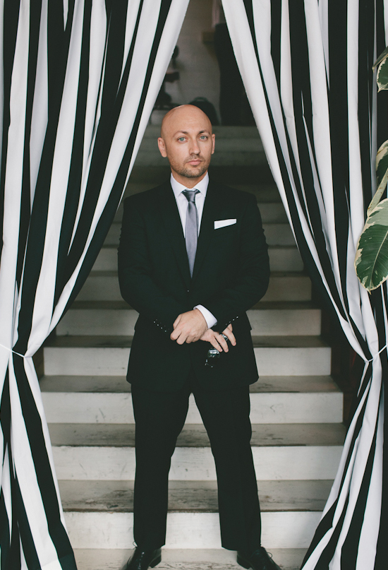 black and white striped curtain and black suit