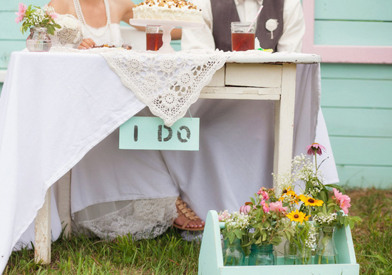 hanging "i do" sign and basket of wild flowers hanging "i do" sign and basket of wild flowers