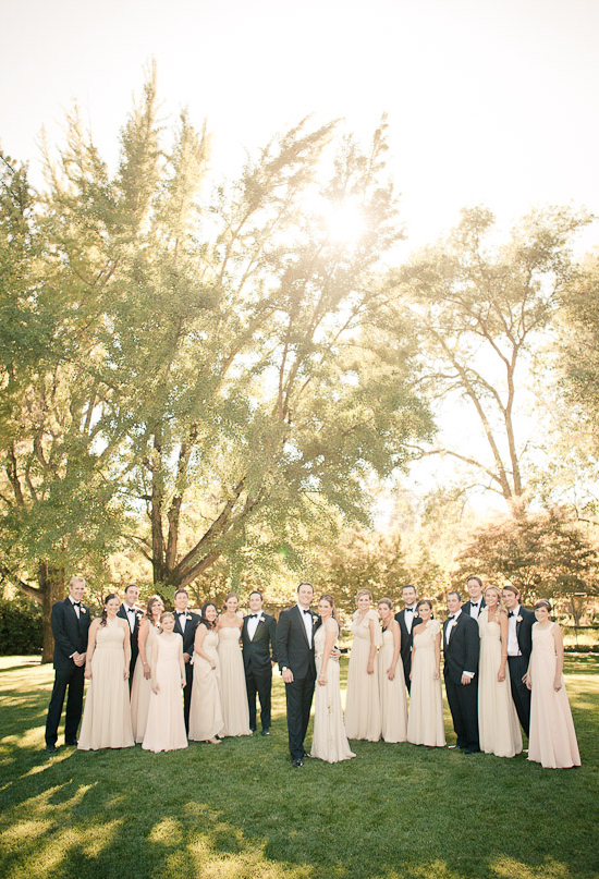 black suits and champagne bridesmaid dresses
