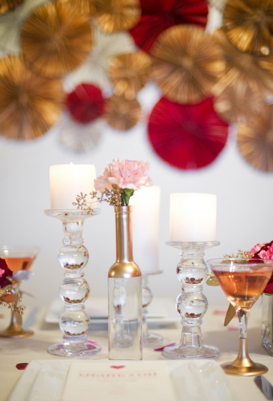 gold painted bottle vase and pink flowers