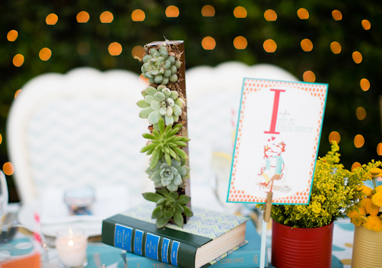 letter terrariums and stacked books table decor letter terrariums and stacked books table decor