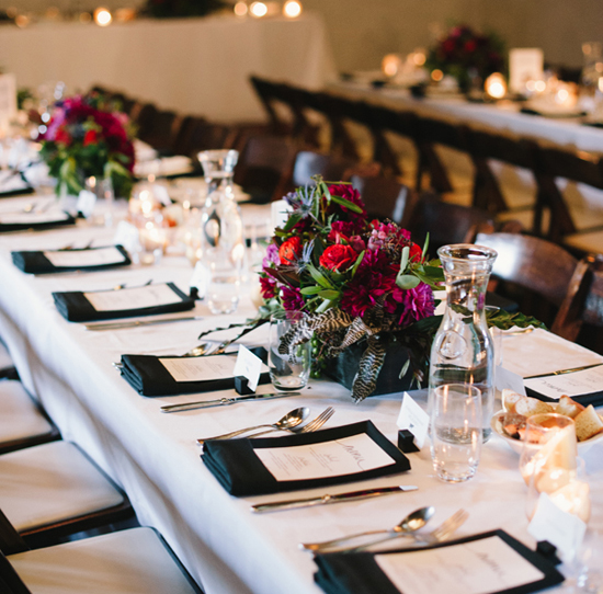 black and white table linens and colorful floral centerpieces | Photo by Jessica Burke black and white table linens and colorful floral centerpieces | Photo by Jessica Burke