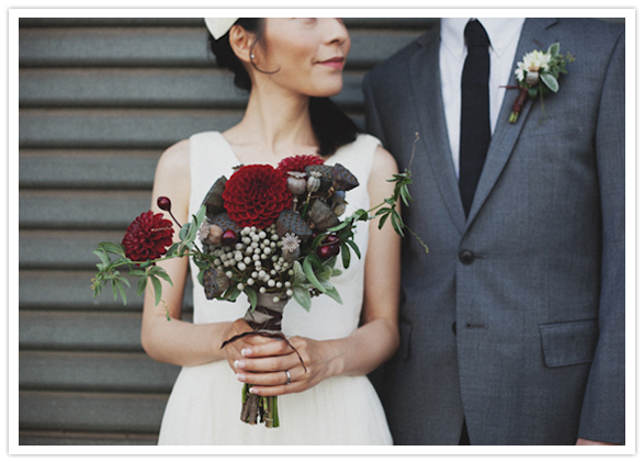 Floral arrangements featured Red Dahlias, Grey Seed-pods and Passionfruit Ivy. 
