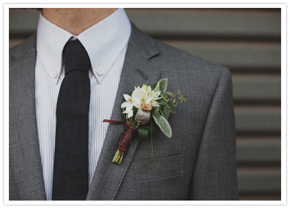 Boutonniere featured White Chincherinchee and a berry sprig wrapped in leather. 