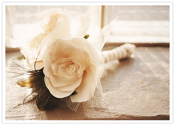 simple white rose and feather bouquet