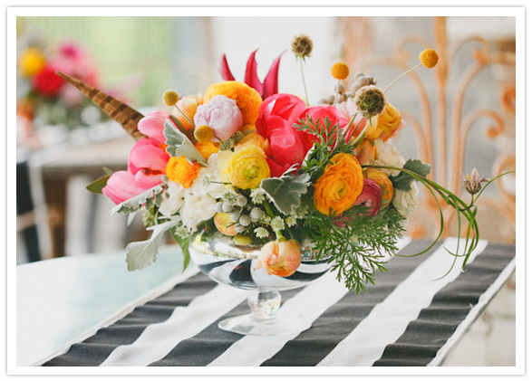 vibrant floral centerpiece and striped linens