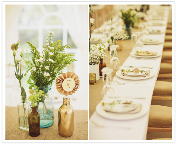simple floral centerpieces in colored bottles