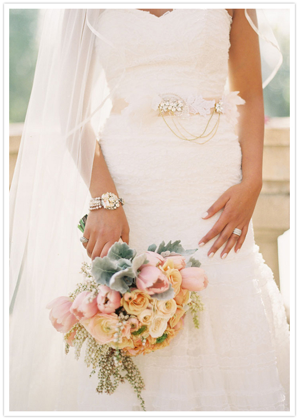 muted hues floral bouquet and jewel-adorned wedding dress