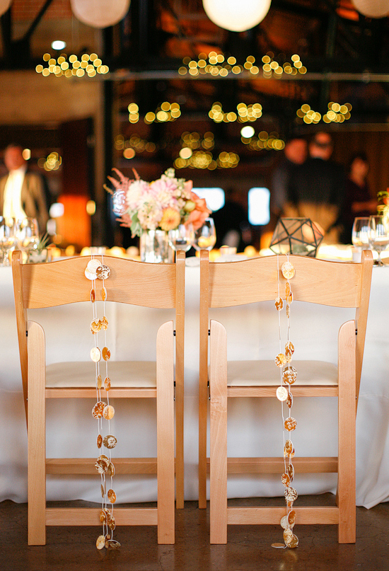 gold paper garland for the bride and groom chairs