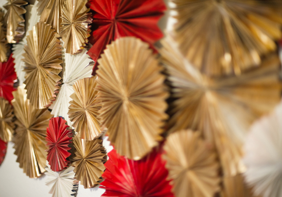 gold and red circular paper wall decor