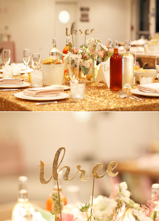 paper cut-out table numbers and gold sparkle linens | Photo by Kimberly Genevieve
