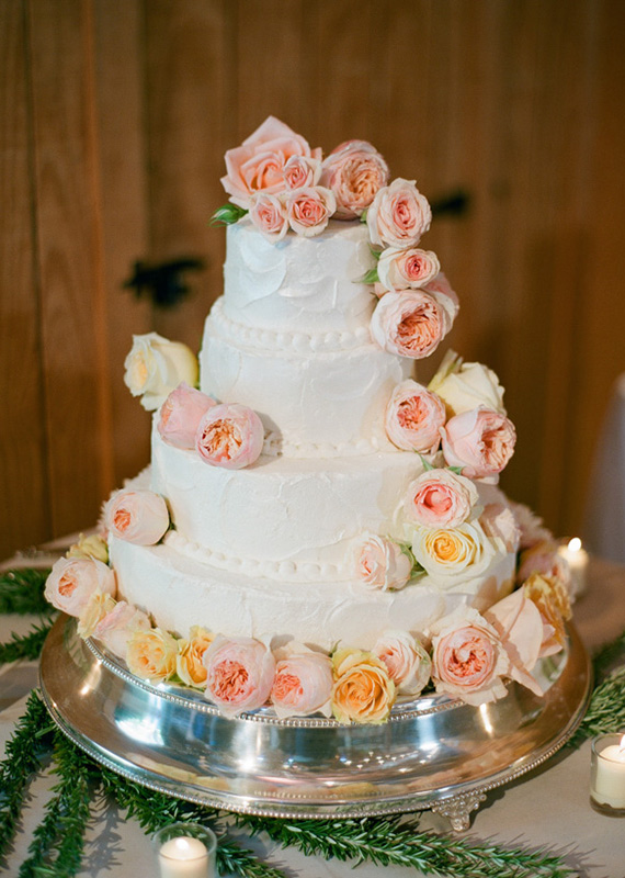 Layered white wedding cake with garden roses | photo by Brandon Chesbro | 100 Layer Cake