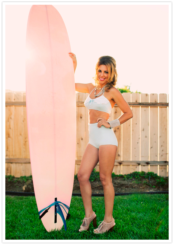 pink surfboard and 60s-inspired swimsuit