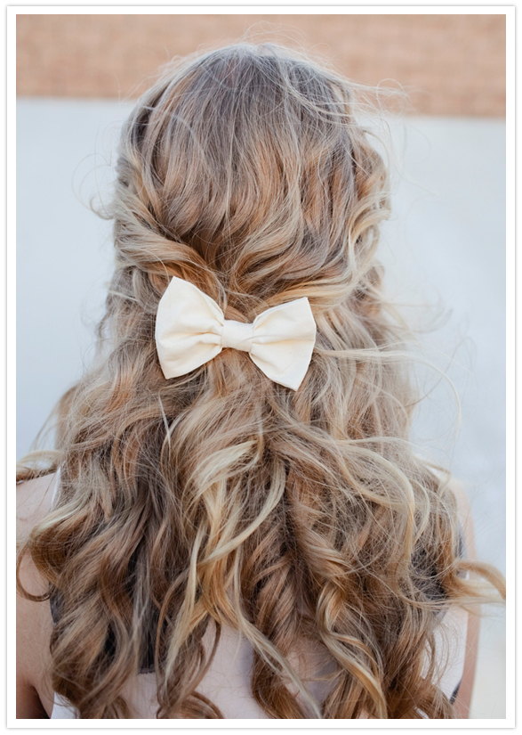 messy curls and white fabric bow