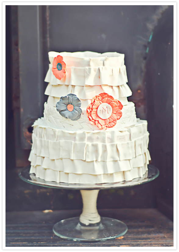 ruffled wedding cake with paper flower accents