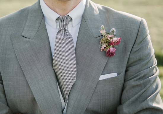 pink and purple boutonniere with grey suit and tie