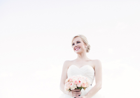 white sweetheart cut wedding dress and peach bouquet
