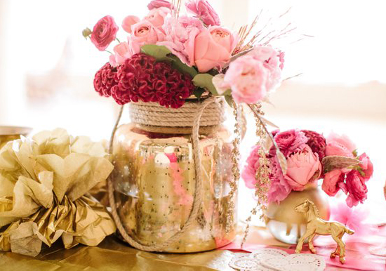 pink roses and red carnations in a gold painted jar