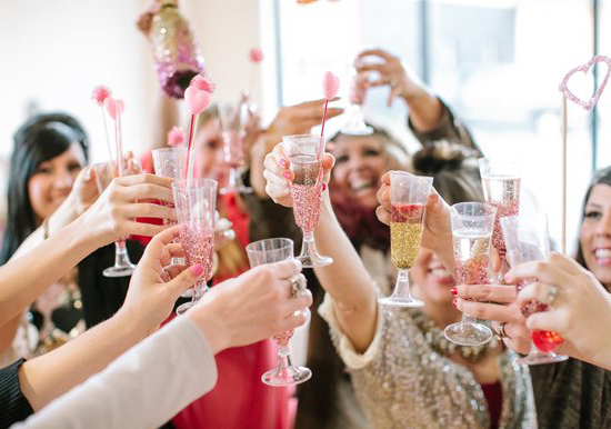 glitter champagne flutes and pink pouf stirrers