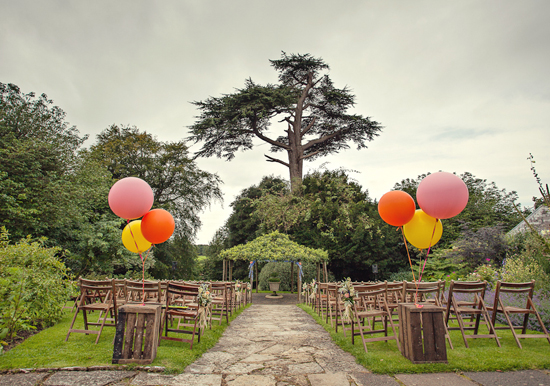 balloon aisle entrance at an outdoor garden wedding | Photo by Marianne Taylor