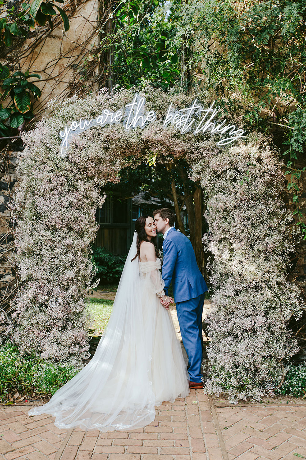 Lush Maui garden wedding with a Baby’s Breath arch