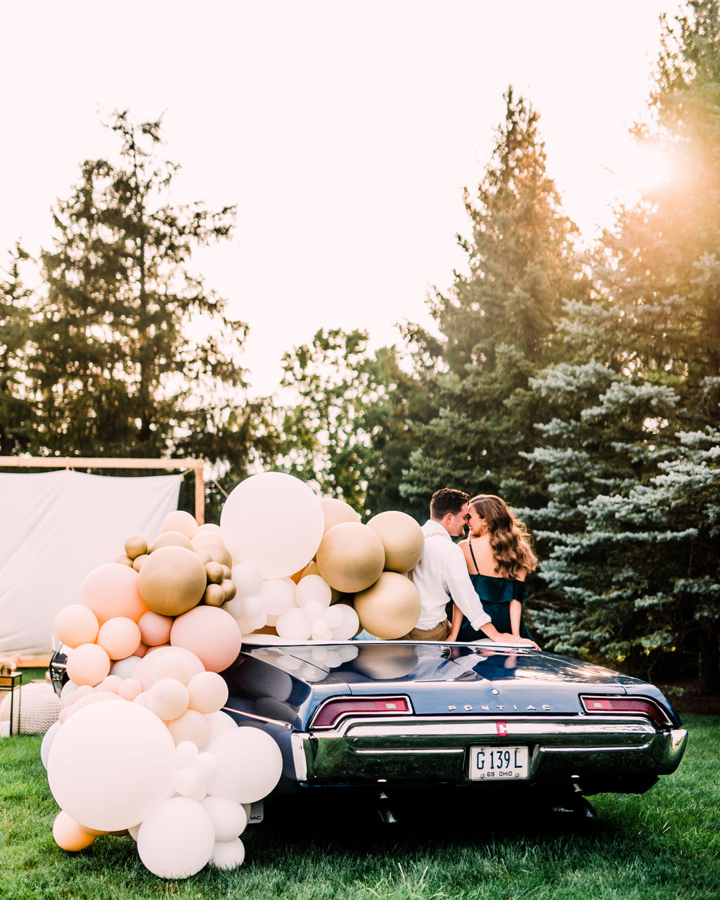 An enchanting DIY drive-in engagement shoot at golden hour