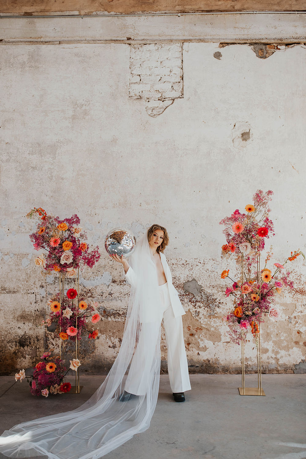 This groovy mod disco-themed wedding is full of flowers & creative backdrop ideas