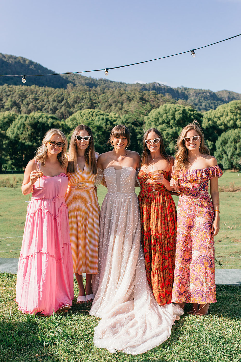 Bride with colorful wedding guest dresses