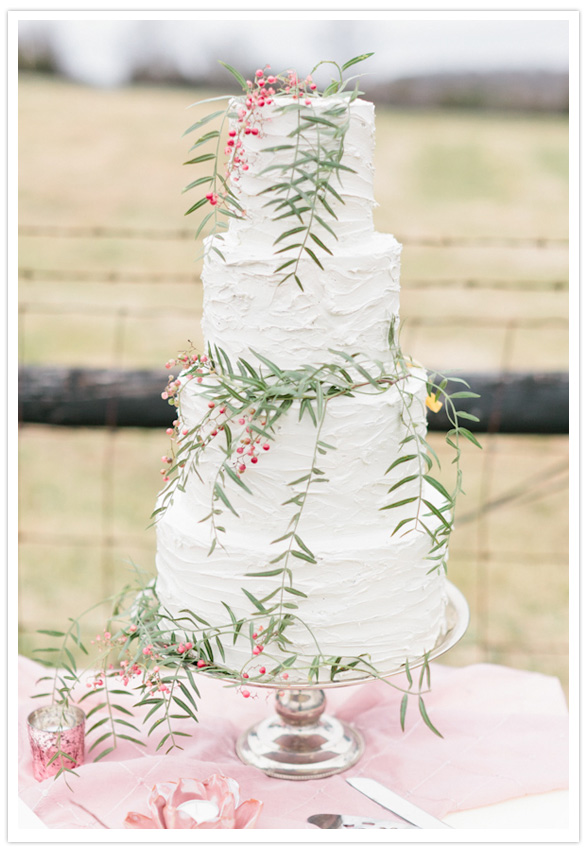 white wedding cake with greenery 
