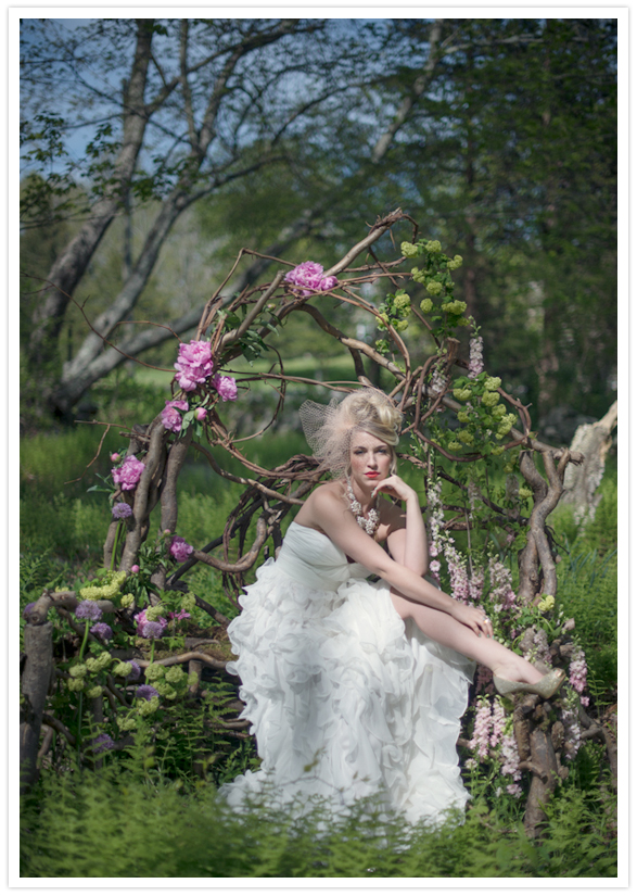 twig and flower throne and ruffled white wedding dress
