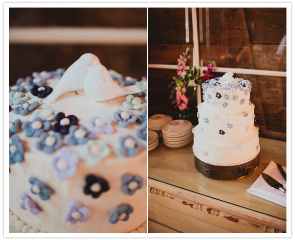 blue flower-adorned wedding cake with lovebirds topper