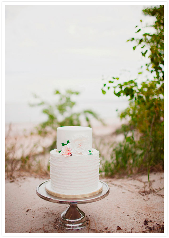 simple white wedding cake with delicate floral accents