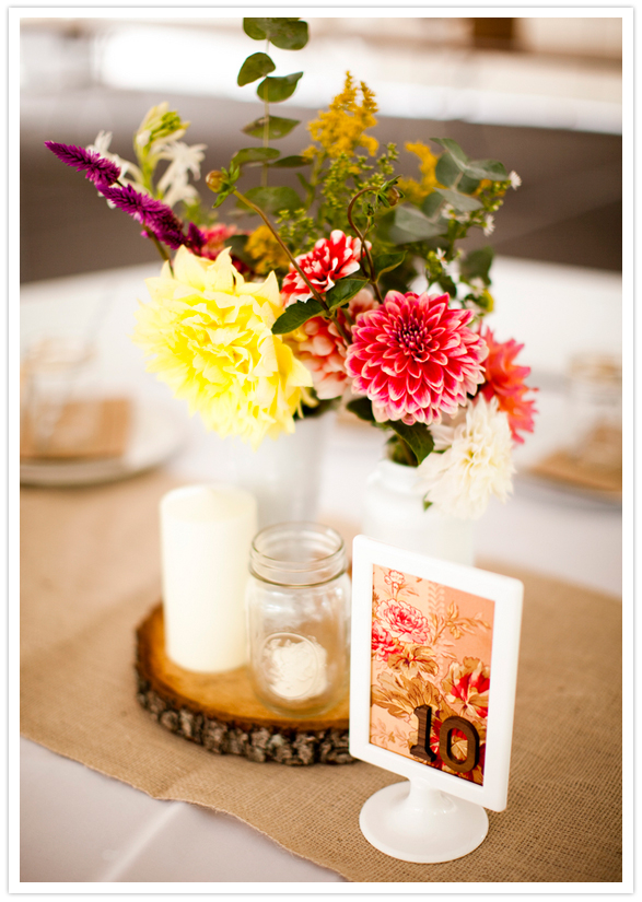 framed floral fabric table numbers and tree bark centerpiece platters