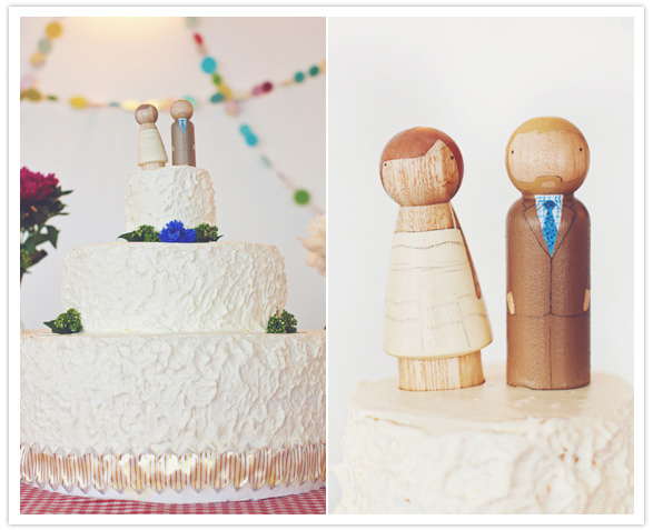 simple white frosted cake and wooden figurine topper