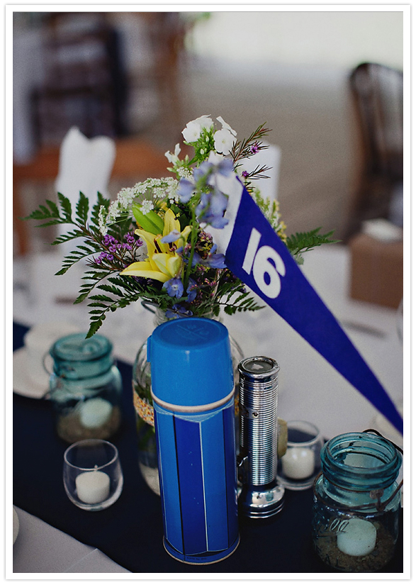 camping thermos and pennant table number centerpieces