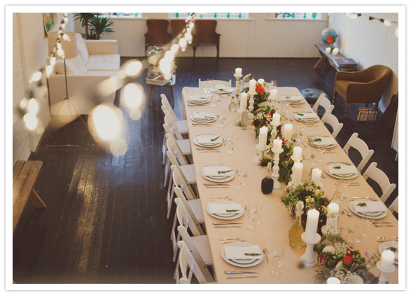 large harvest table covered in wildflower centerpieces