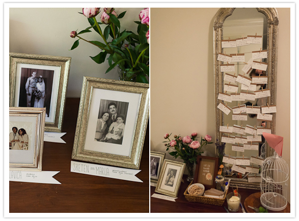 mirror hanging escort cards and framed family portraits