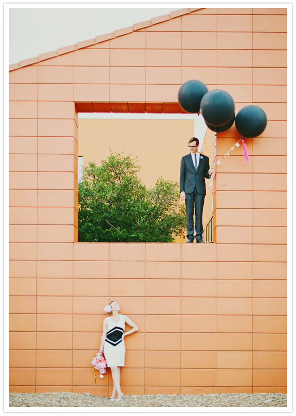 orange brick wall and black balloons