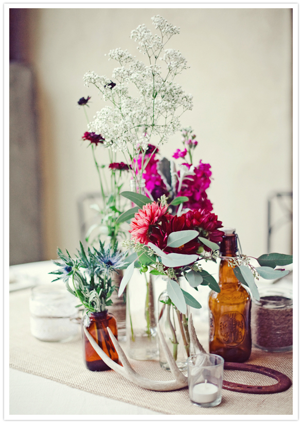 rustic bottle vases and vibrant pink and fuchsia flowers