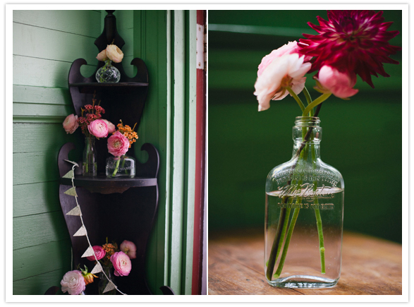 whiskey bottle vases and pink flowers