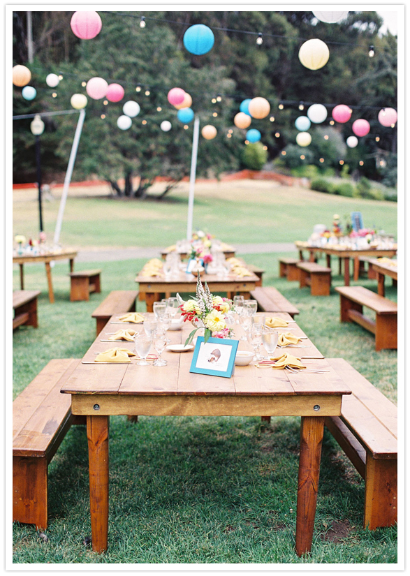 picnic-style reception tables and colorful paper lanterns