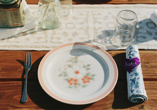 floral plates, custom fabric napkins and mason jar glasses