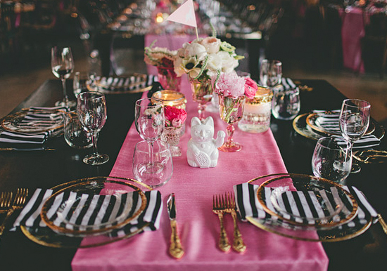 pink table runner, black and white striped napkins and gold flatware