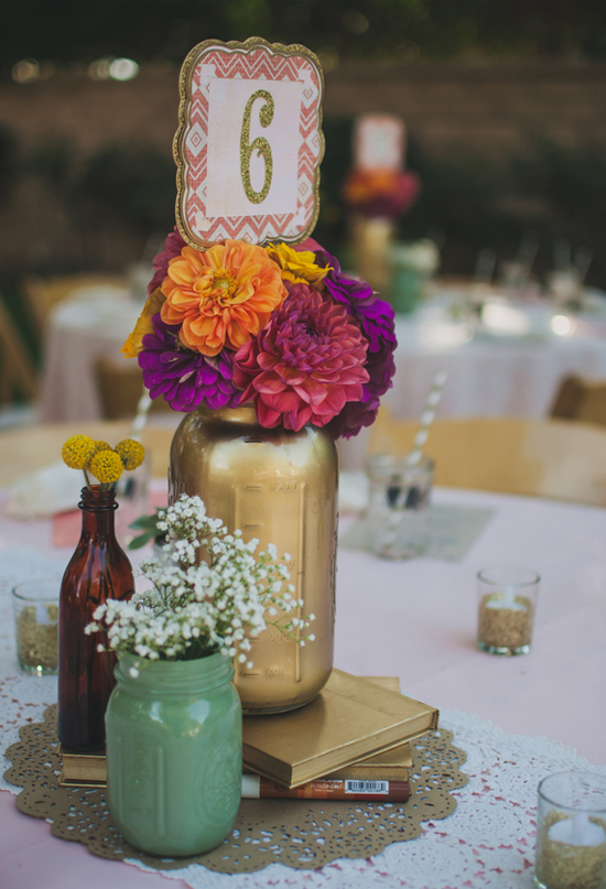 vibrant purple, orange and pink flowers in a painted mason jar centerpiece
